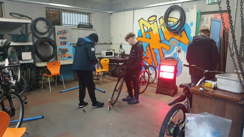 Kids in Buttershaw working on bikes in the Youth Centre.